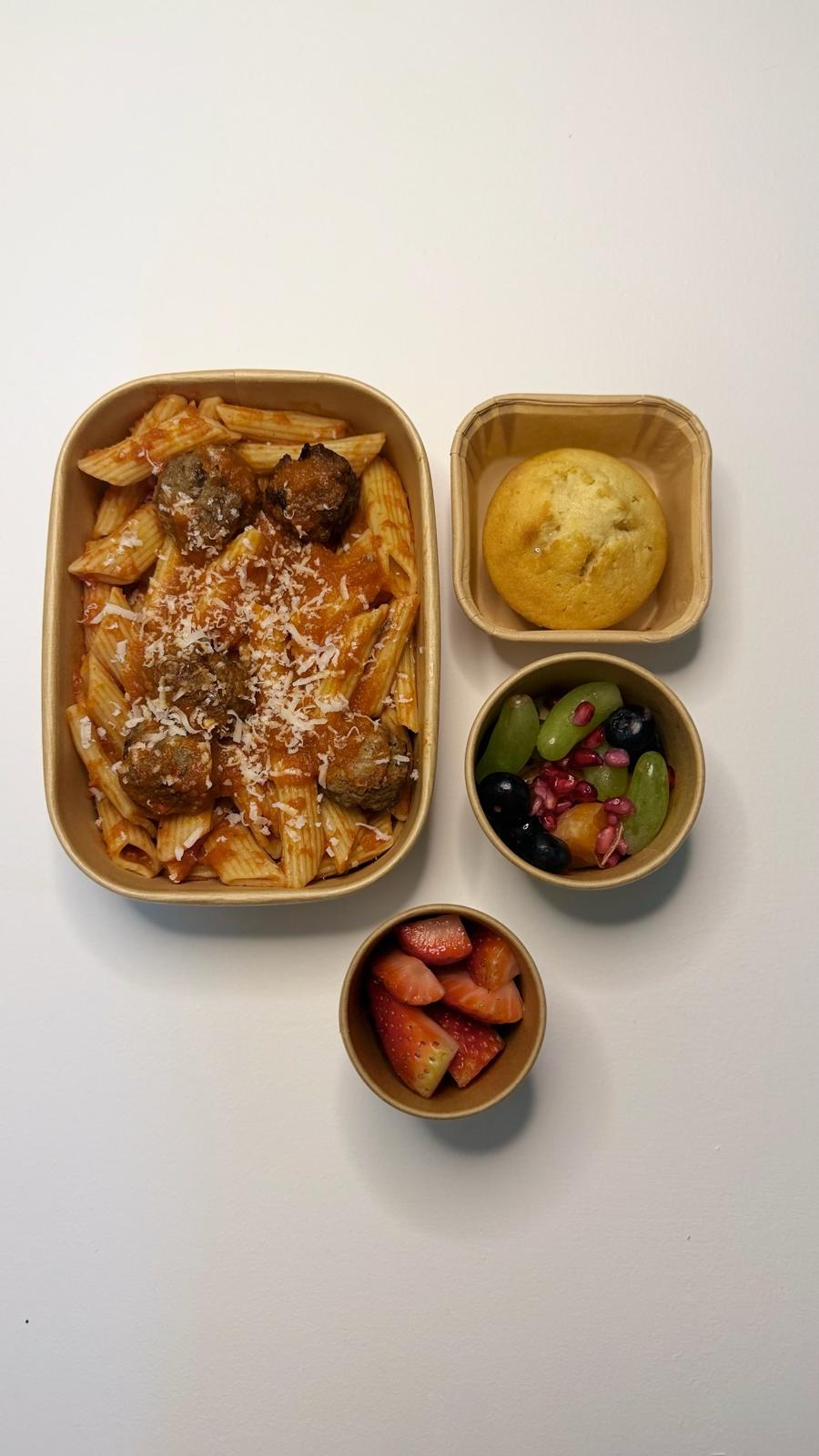 Pasta with meatballs, a corn muffin, mixed fruit and fresh strawberries