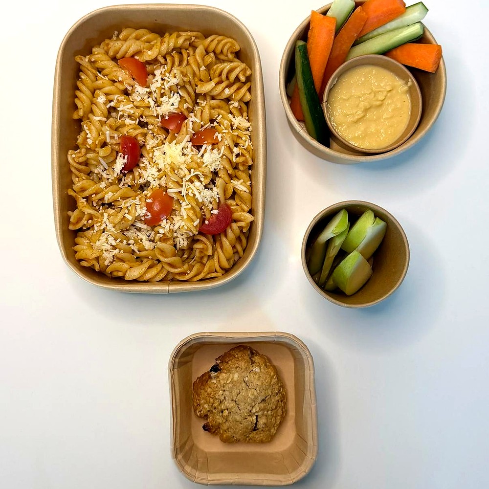 Tomato pasta with carrot and cucumber, hummus, apple and an oat cookie