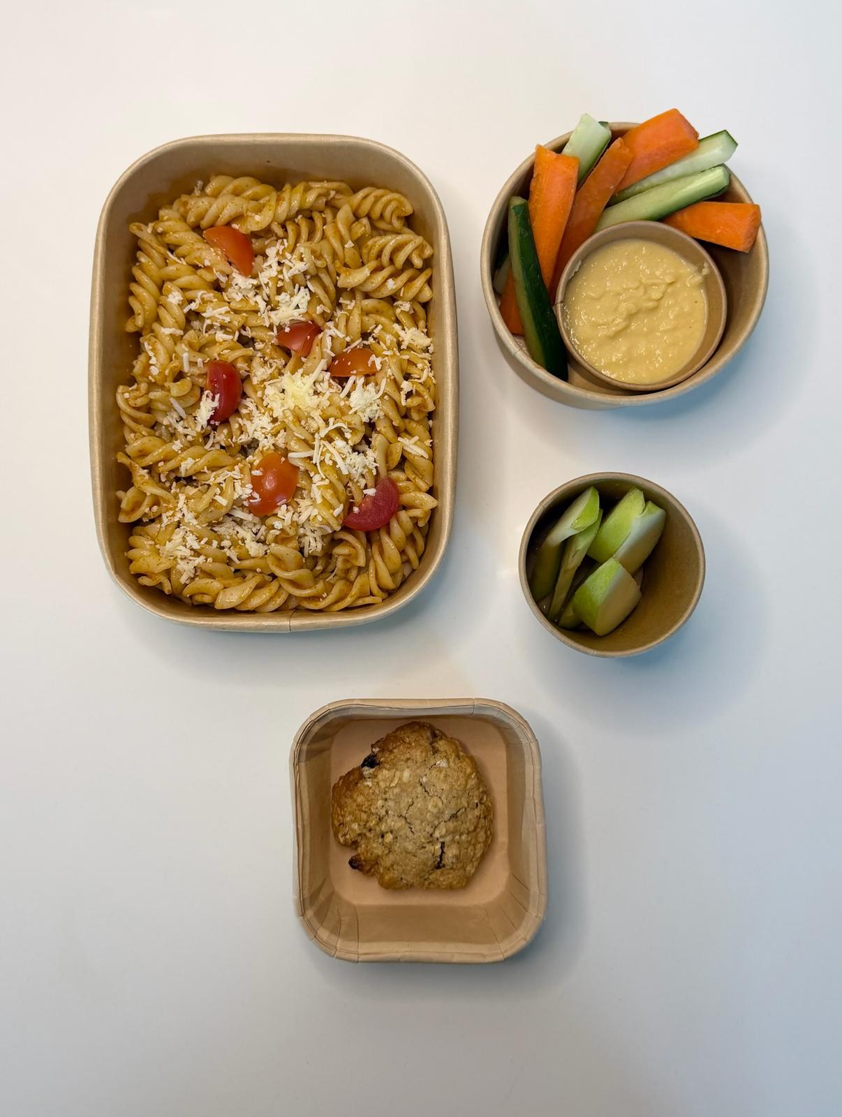 Tomato pasta with carrot and cucumber, hummus, apple and an oat cookie